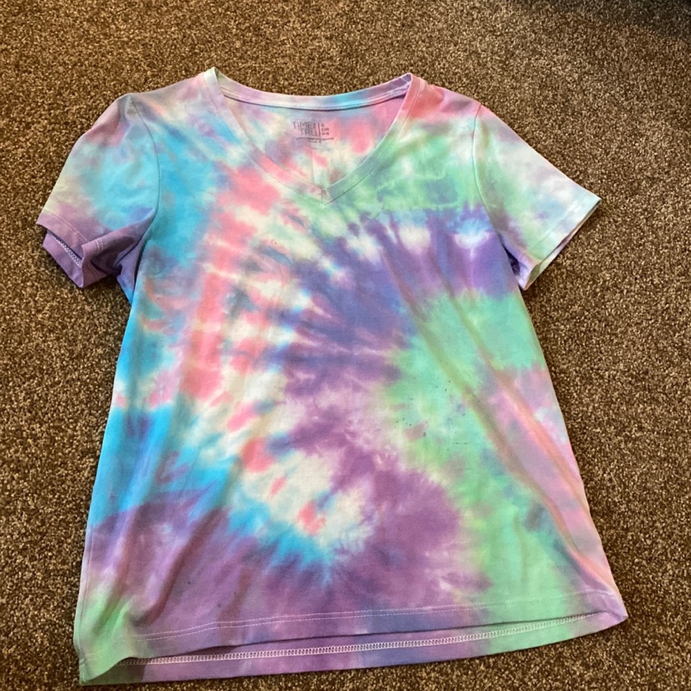 It is a Tye-Dye shirt, size Small, and it is purple, white, blue, green, pink.
